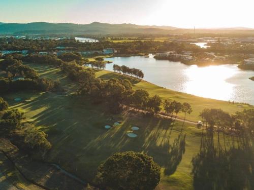 an aerial view of a golf course next to a lake at Belle Vista - Luxury Canal Front Home near Theme Parks with Pool in Gold Coast
