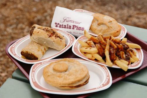 a tray with four plates of food and french fries at Belle Vista - Luxury Canal Front Home near Theme Parks with Pool in Gold Coast