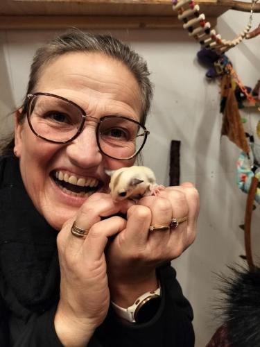 a woman holding a small puppy in her hands at Hohenwarte in Højer