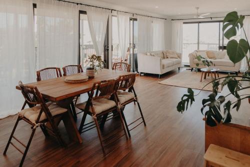 a living room with a wooden table and chairs at Coastal Home in Exmouth