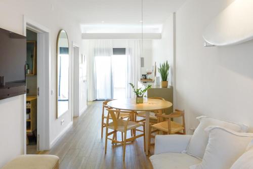 a living room with a table and a couch at Beach front right on the Sand Luxury semi-detached 3 bed Villa in Faro