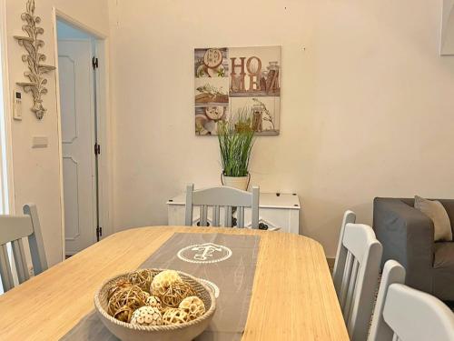 a dining room table with a bowl of food on it at Casa do Carmo Fuzeta by Junto ao Mar in Fuzeta