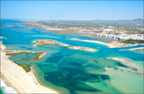 an aerial view of a beach and the ocean at Casa do Carmo Fuzeta by Junto ao Mar in Fuzeta