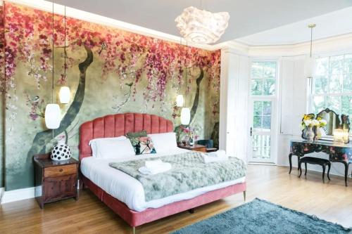 a bedroom with a bed and a floral wall at Hillthorpe Estate - 14 Bed Manor House with Hot Tubs and Secluded Gardens in East Hardwick
