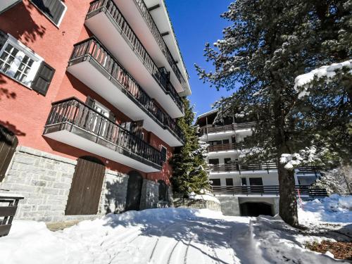 an apartment building with snow in front of it at Apartment Casa Rossa by Interhome in Madesimo