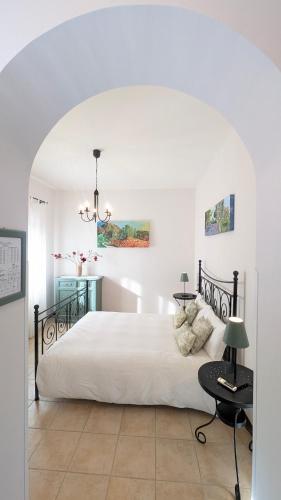a bedroom with a large white bed and a table at Agriturismo Mammarella in Altavilla Silentina