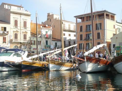 boats are docked in the water at Casa Ilva in La Maddalena