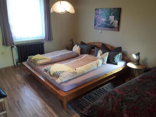 a bedroom with a bed with a wooden frame at Ferienhaus Bremer Grillenberg in Grillenberg