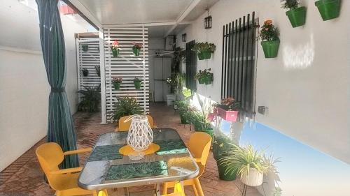 a patio with a table and chairs and plants at Charming villa near Córdoba with private pool in Encinarejo De Córdoba