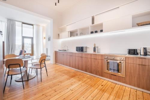 a kitchen and dining room with a table and chairs at Top Floor New Duplex Stunning View In Trendy St Gilles in Brussels