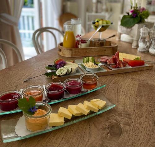 a table with two plates of cheese and other foods at Gutshaus Krimvitz Kleines Doppelzimmer inkl Frühstück in Putbus