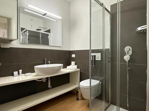 a bathroom with a sink and a toilet and a shower at Luxury Battisti in Padova