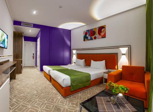 a hotel room with a bed and a couch at ALBA HOTEL & SPA in Baku