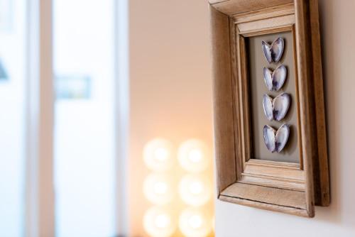 a mirror with hearts in it on a wall at The Hayloft in Edwardstone