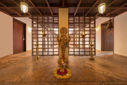 a statue in the middle of a room with lights at Club Mahindra Kensville in Ahmedabad