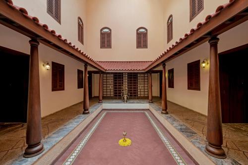 an empty hallway of a building with a yellow bowl on the floor at Club Mahindra Kensville in Ahmedabad