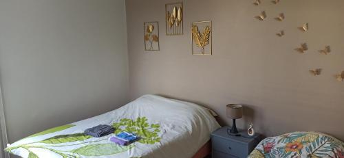 a bedroom with a bed with a white comforter at Entre Ville & Nature-Sejour idéal a Massy in Massy