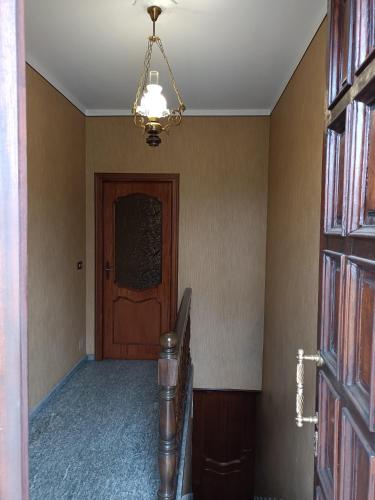 a hallway with a door and a chandelier at La Ca' di Domenico in Barge