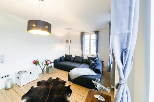 a living room with a couch and a table at DesignLodge Apartments in Bad Sobernheim