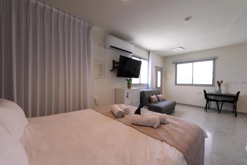 a bedroom with a large bed with two pillows on it at וילה מינרל villa mineral in Neve Zohar