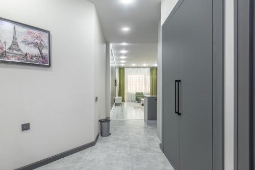 a hallway with white walls and a picture of the eiffel tower at Passage Hotel in Baku