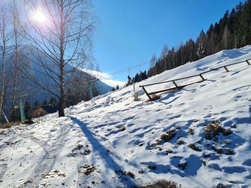a snow covered hill with the sun in the background at Chalet Ski in by Globalimmoservice in Bad Kleinkirchheim