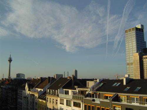 a view of a city with buildings and a skyscraper at Apartments Atomis Hotel Düsseldorf City in Düsseldorf