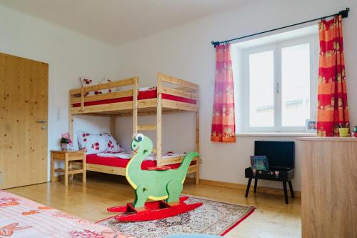 a childs bedroom with a dinosaur toy on a rug at Glatz Hof Appartement Nockberge in Gnesau