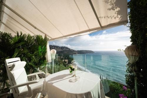 a white table with a view of the ocean at Hôtel Le Roquebrune in Roquebrune-Cap-Martin