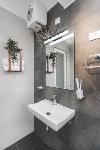a bathroom with a white sink and a mirror at Horizon View Mountain Bliss in Kandy