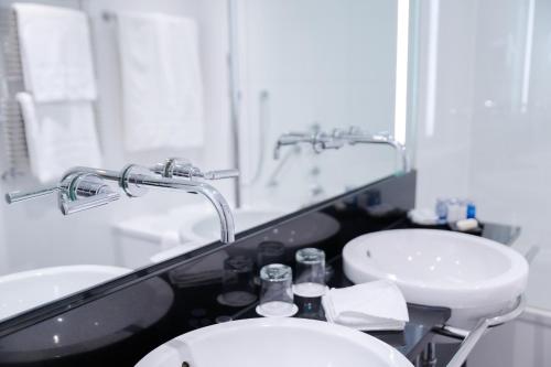a bathroom with a sink and a toilet and a mirror at Ambassade Hotel in Amsterdam