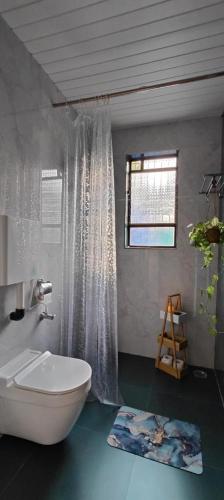 a bathroom with a white bath tub and a window at Paradise Farm Alibaug in Bhāweghar