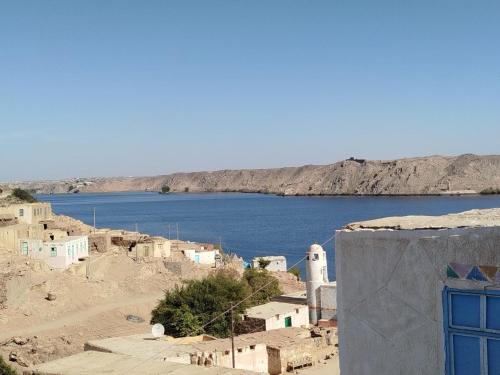 a view of a body of water with houses and a blue door at Nubian Dreams House in Jazīrat Fīlah