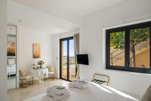 a bedroom with a bed and a dining room with a table at Hôtel Le Roquebrune in Roquebrune-Cap-Martin