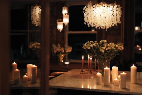 a bunch of candles on a table with flowers at The View, luxury apartment in Berwick-Upon-Tweed