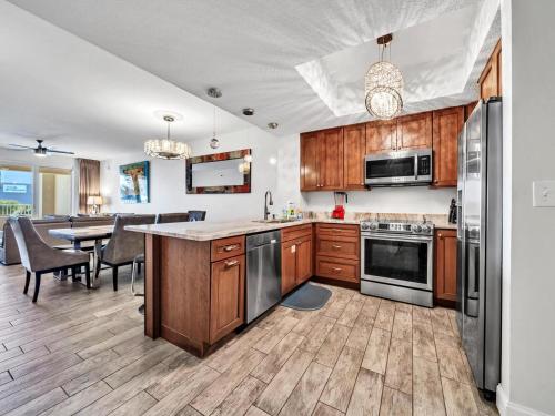 a kitchen with wooden cabinets and stainless steel appliances at Ariel Dunes 209 in Coffeyville