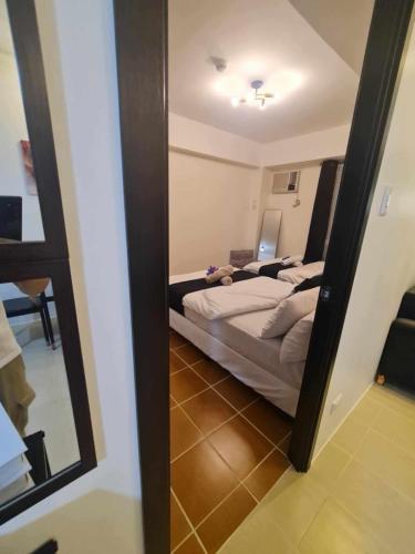 a bedroom with a bed and a mirror at Spacious Staycation in Pasig Urban Metro Escape in Manila