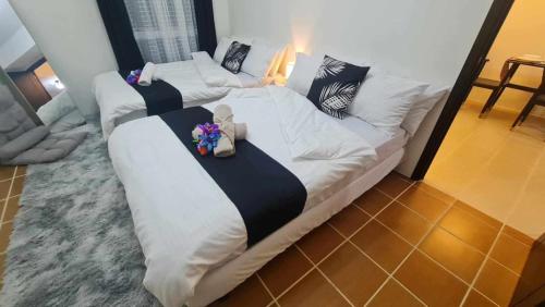 two beds in a room with flowers on them at Spacious Staycation in Pasig Urban Metro Escape in Manila