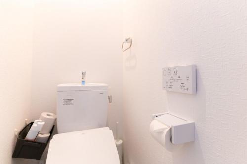 a bathroom with a white toilet in a room at Shirara Terrace B in Shirahama