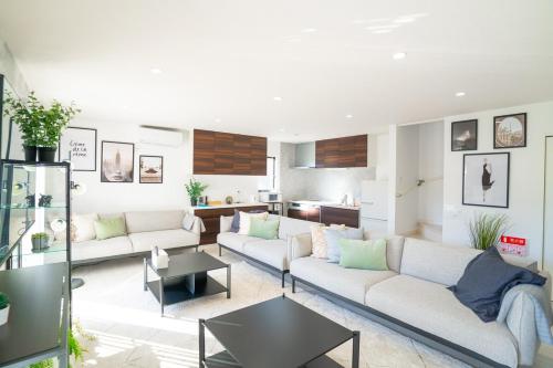 a living room with two couches and a table at Shirara Terrace B in Shirahama
