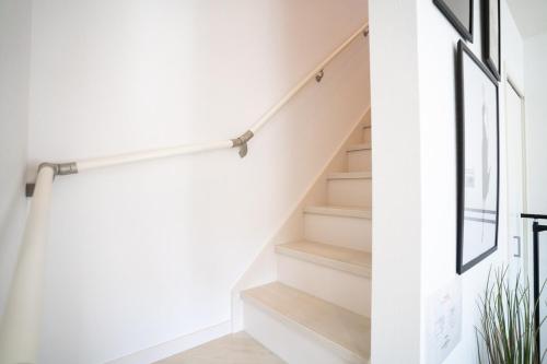a staircase in a house with white walls and wooden floors at Shirara Terrace B in Shirahama