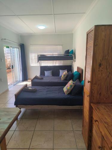 a bedroom with a bed with blue sheets and pillows at Sunny Stay in Groblersdal