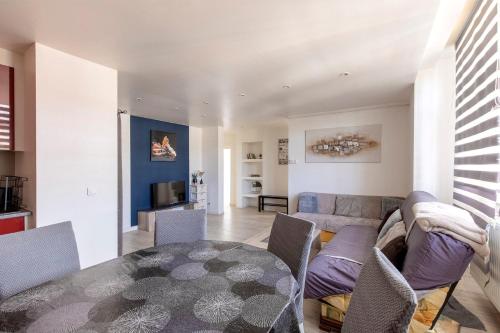 un salon avec un canapé et une table dans l'établissement Vue sur Saint Quentin Un Séjour à Part, à Longeville-lès-Metz