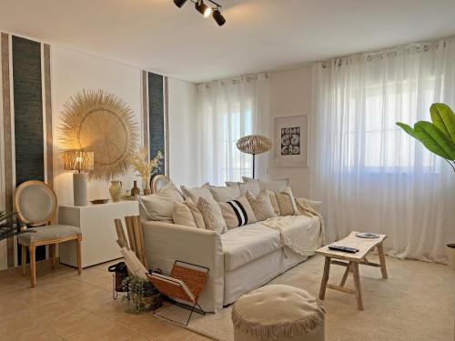 a living room with a white couch and a table at APF Beach T2 Cabanas Home by Junto ao Mar in Cabanas de Tavira