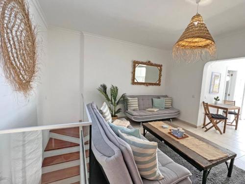 a living room with a couch and a table at Casa Alice - Olhão in Olhão