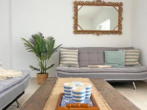 a living room with a couch and a coffee table at Casa Alice - Olhão in Olhão