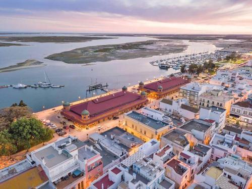 an aerial view of a city with a harbor at Casa Alice - Olhão in Olhão