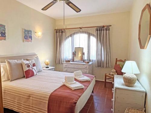 a bedroom with a large bed and a window at A Minha Casinha - Marim Olhão By Junto ao Mar in Moncarapacho