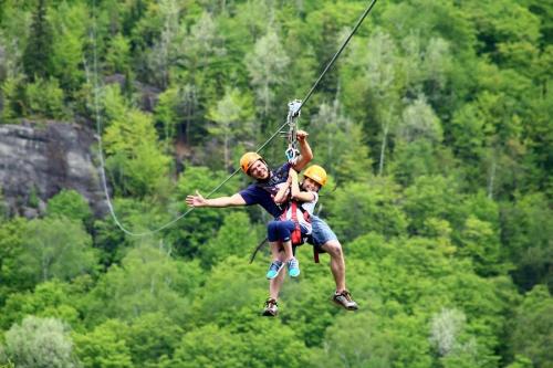 two people on a zip line in at Magnifique VUE LAC et SKI in Mont-Tremblant
