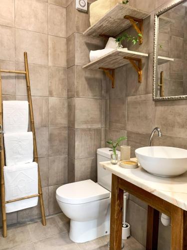 a bathroom with a toilet and a sink at Casa Salinas, Elegant Flat w patio in Taviras Historical Centre in Tavira